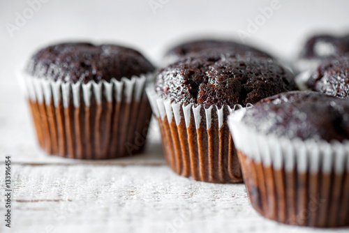 Chocolate muffins on a white rustic wooden table - selective focus, copy space