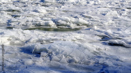 Broken ice collecting on shore in the winter