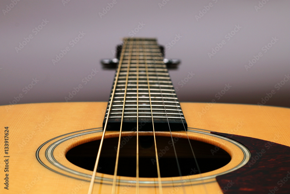 Part of a wooden acoustic guitar Part of a wooden acoustic guitar