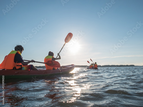 Adventure people on the kayak boat in the ocean