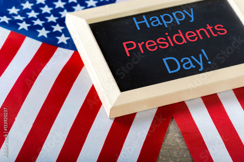 the text happy presidents day written in a chalkboard and a flag of the United States