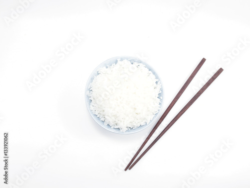 Rice in a bowl with chopsticks isolated top view
