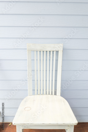 White chair with blue plank wall