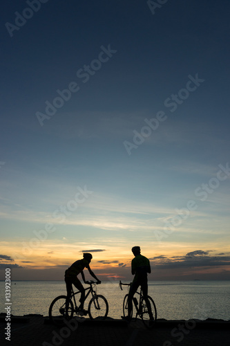 Silhouettes of Cyclists on bicycle at the ocean in the sunset sc © littlekop
