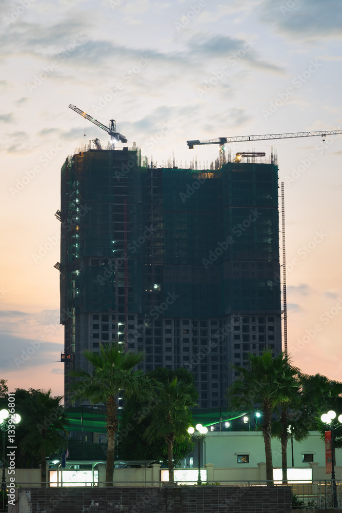 Silhouette of construction site at sunset