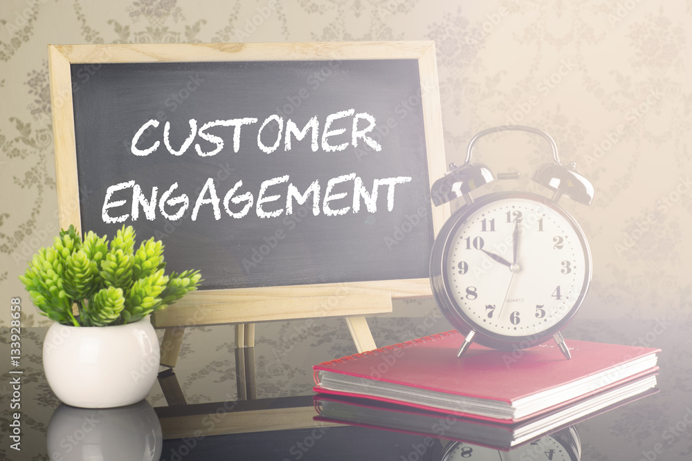 Customer Engagement on blackboard with clock and flare Customer Engagement on blackboard with clock and flare