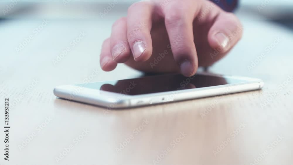 CU RL DOLLY Caucasian man using his phone on a wooden table, finger pointing screen. Selective focus. 4K UHD 60 FPS slow motion CU RL DOLLY Caucasian man using his phone on a wooden table, finger pointing screen. Selective focus. 4K UHD 60 FPS slow motion