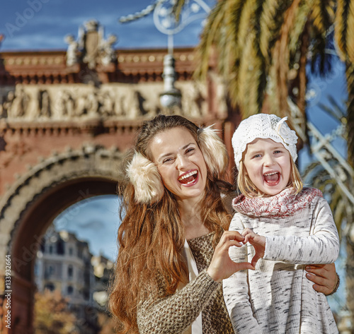 mother and child in Barcelona showing heart shaped hands photo