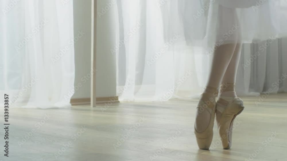 Close-up Shot of Ballerina's Legs. She's Dancing and Spinning on Her Pointe Ballet Shoes. She's Wearing White Tutu Dress. Shot in a Modern Studio. Shot on RED EPIC-W 8K Helium Cinema Camera. Close-up Shot of Ballerina's Legs. She's Dancing and Spinning on Her Pointe Ballet Shoes. She's Wearing White Tutu Dress. Shot in a Modern Studio. Shot on RED EPIC-W 8K Helium Cinema Camera.