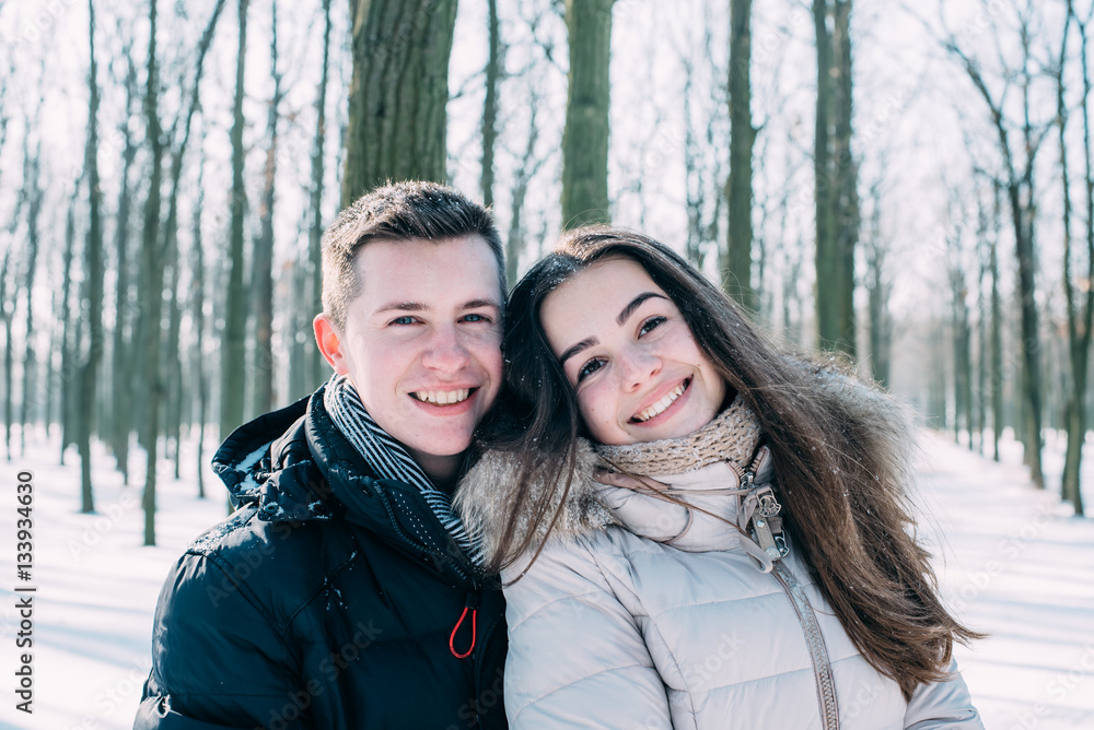 young loving couple having fun in snowy park
young loving couple having fun in snowy park