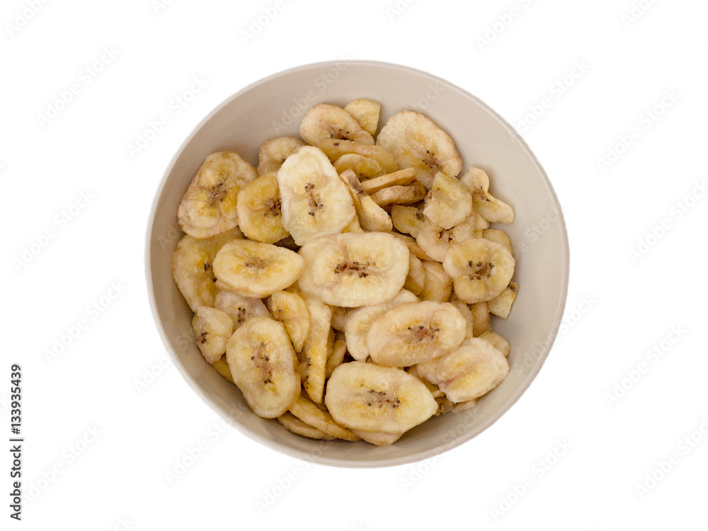 Dried bananas in a bowl on a white background