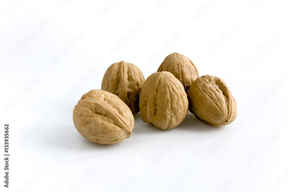 Walnuts isolated on white background. Still-life picture taken in studio with soft-box. Walnuts isolated on white background. Still-life picture taken in studio with soft-box.