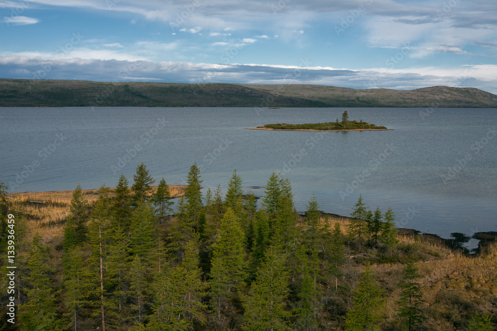 View from the shore of the lake with an island. Lake Labynkyr. Yakutia. Russia.