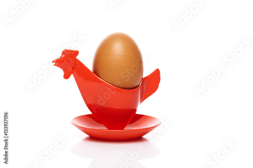Brown egg in a red cup