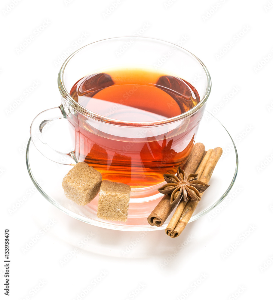 Transparent cup tea, sugar, anise and cinnamon steaks on white