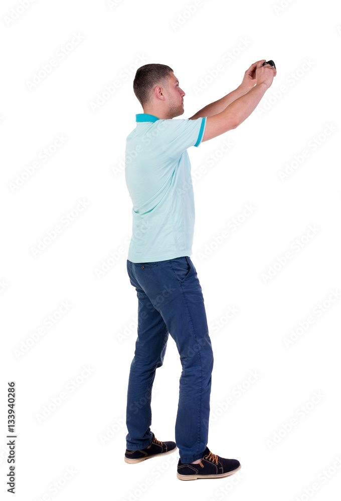 Back view of man photographing. tourist with camera. Back view of man photographing. tourist with camera.