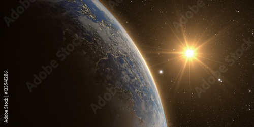 Fototapeta Naklejka Na Ścianę i Meble -  orange Sunrise over earth as seen from space. With stars background.