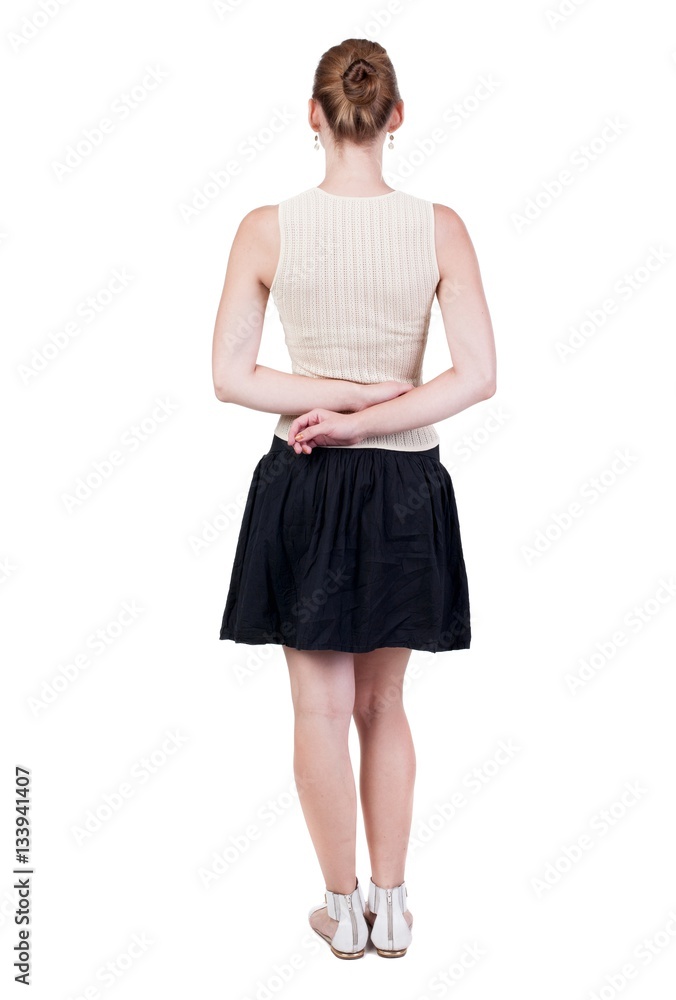 Naklejka premium back view of standing young beautiful woman.