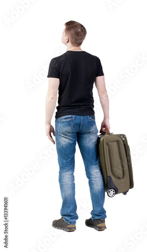 Back view of man with  green suitcase looking up. © ghoststone