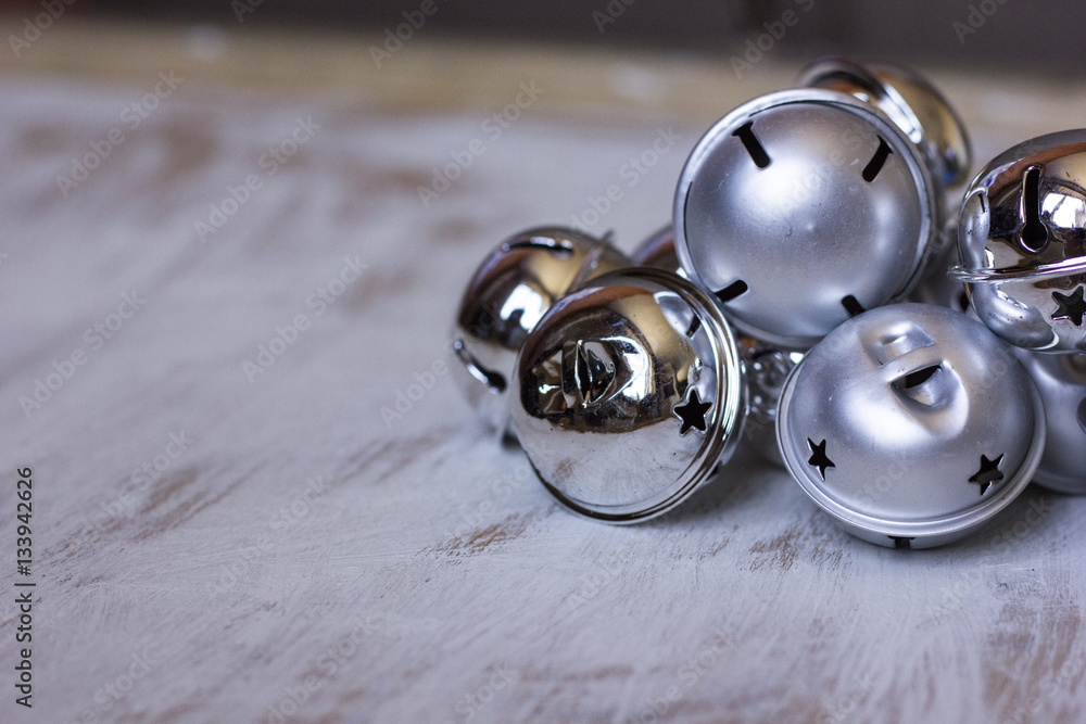 Christmas decoration with jingle bells on white wooden table. Christmas decoration with jingle bells on white wooden table.