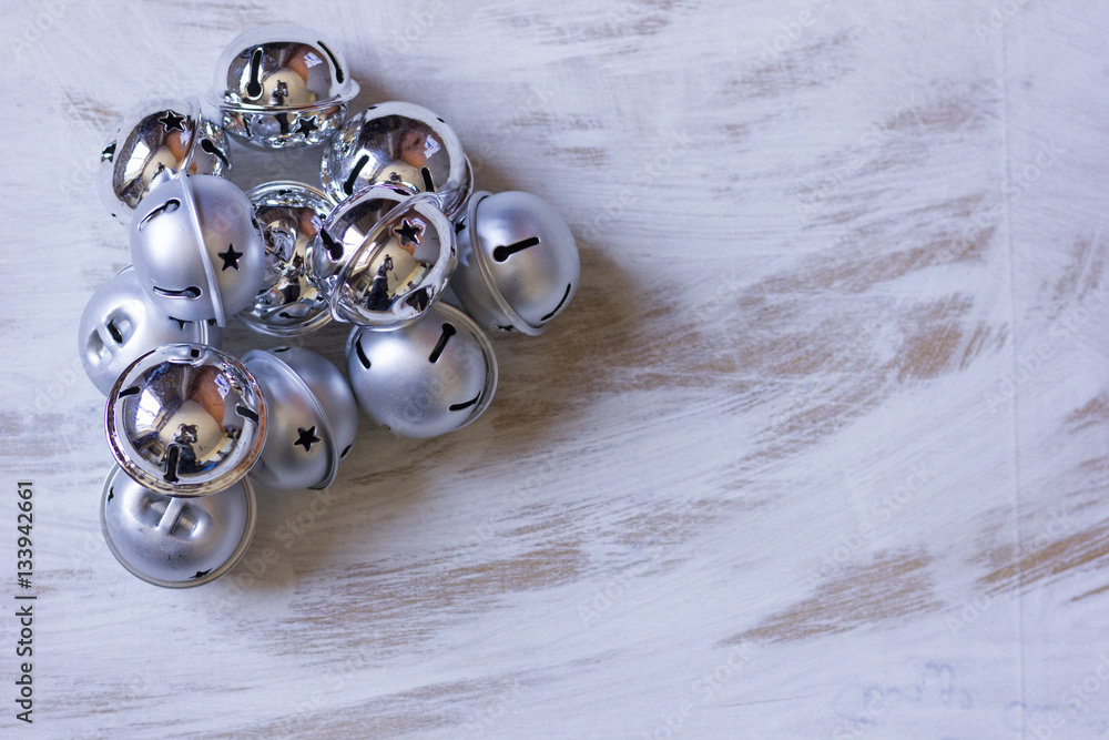 Christmas decoration with jingle bells on white wooden table. Christmas decoration with jingle bells on white wooden table.
