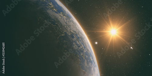 orange Sunrise over earth as seen from space. With stars background.