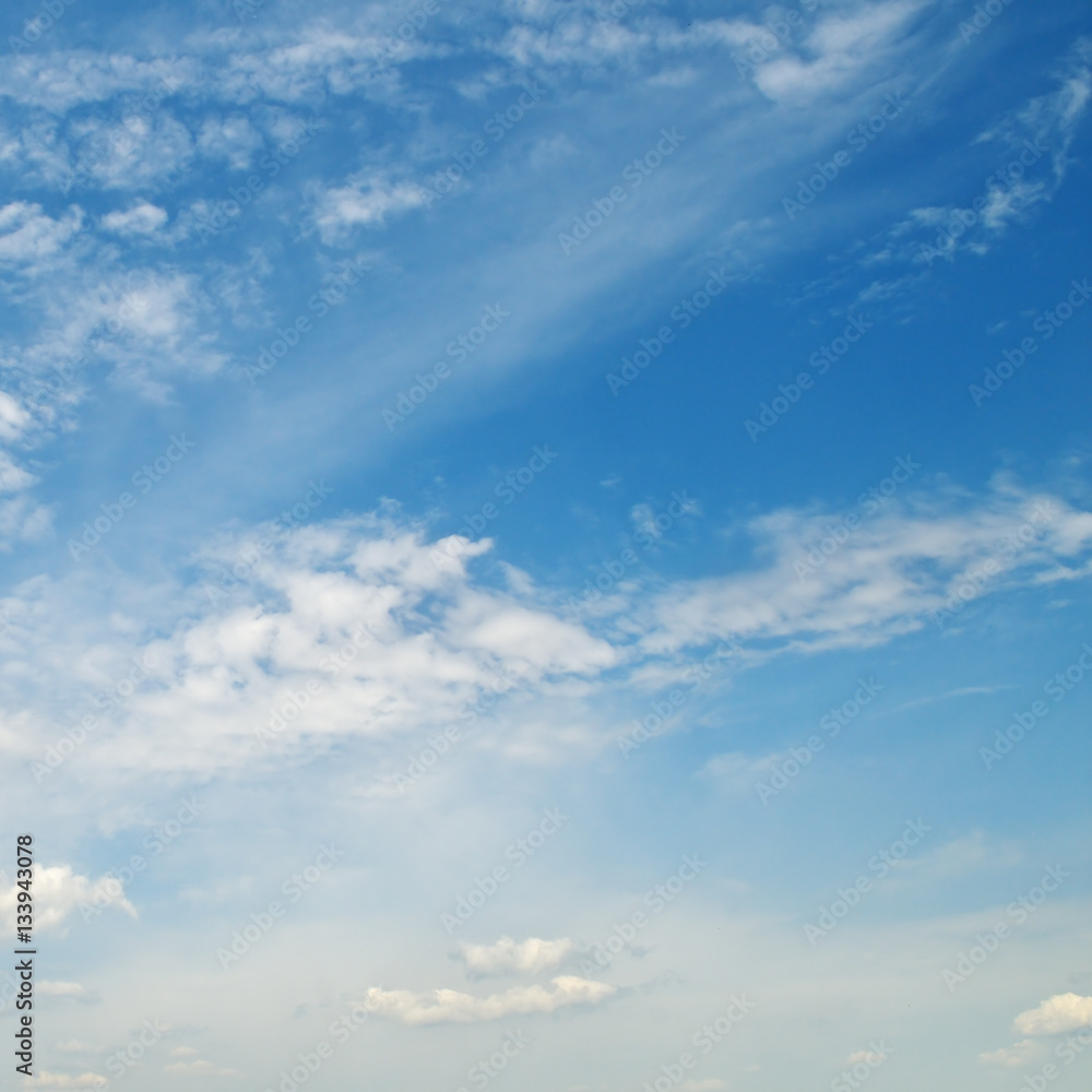 light cumulus clouds in the blue sky