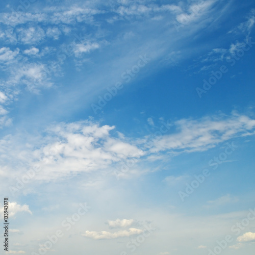 light cumulus clouds in the blue sky