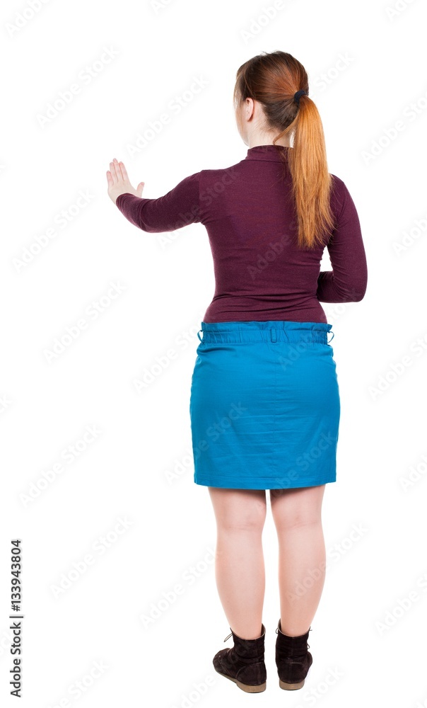 back view of young woman presses down on something. back view of young woman presses down on something.