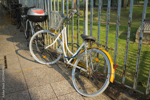 Bike locked to metal fence of park in Singapore