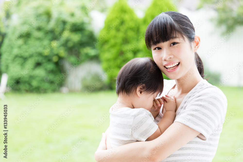 portrait of asian mother hugging baby in park portrait of asian mother hugging baby in park