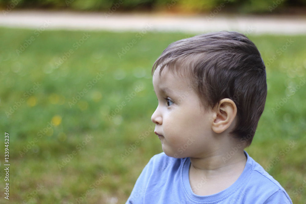 serious little kid looking to the left serious little kid looking to the left