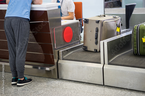 Luggage weighting at check-in desk at Asia airport photo