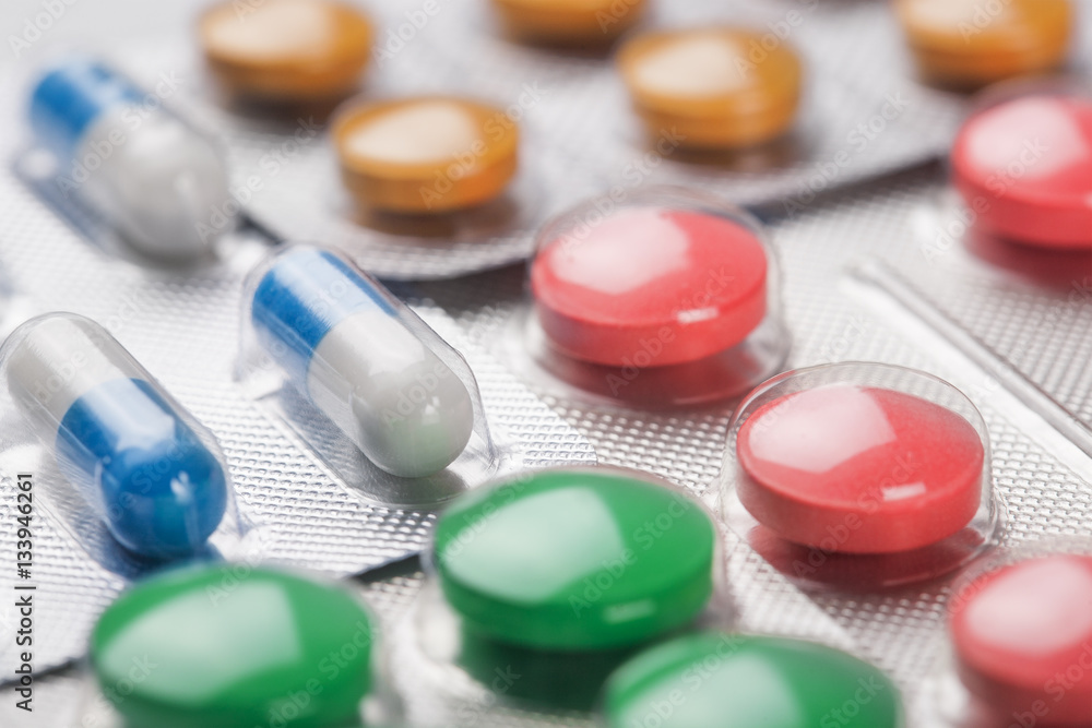 Colored medical pills in the small plastic silver boxes Colored medical pills in the small plastic silver boxes