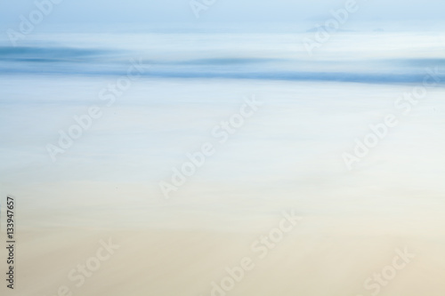 Abstract blurry background of beach and sea waves in the morning with vintage color style.