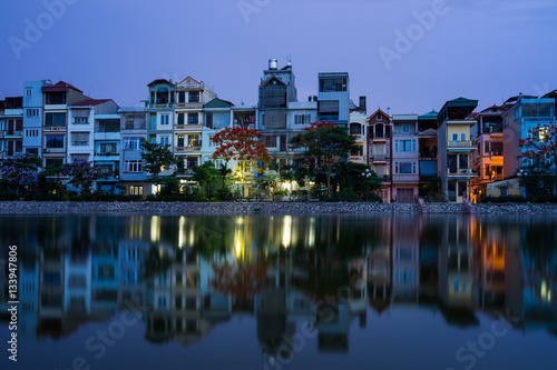 Houses with reflection at twilight in Hanoi, Vietnam