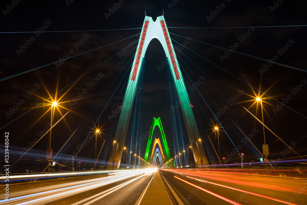 Obraz premium Long exposure Nhat Tan cable stayed bridge at night. The bridge crossing Red River.