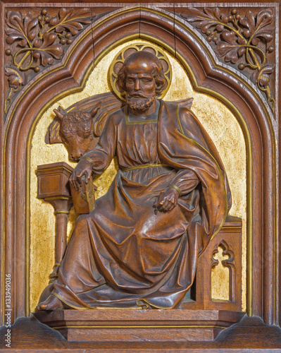 VIENNA, AUSTRIA - DECEMBER 19, 2016: The carved relief of St. Luke the Evangelist in church Brigitta Kirche by unknown artist of 19. cent.