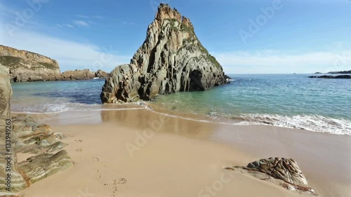 Atlantic Ocean summer coast view from sandy Mexota beach and pointed rock (Spain). 
 photo