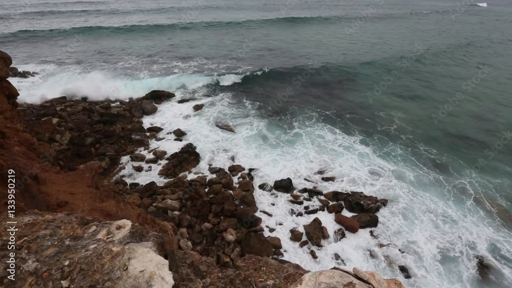 Summer Atlantic rocky coast landscape with waves breaking on stones, Algarve, Portugal.
Summer Atlantic rocky coast landscape with waves breaking on stones, Algarve, Portugal.