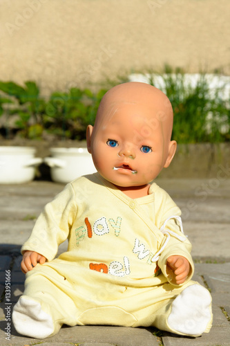 Creepy old doll with blue eyes. Scary toy.