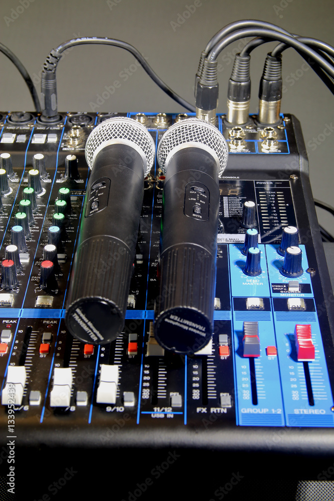 Wireless microphones lying on the mixing console. Wireless microphones lying on the mixing console.