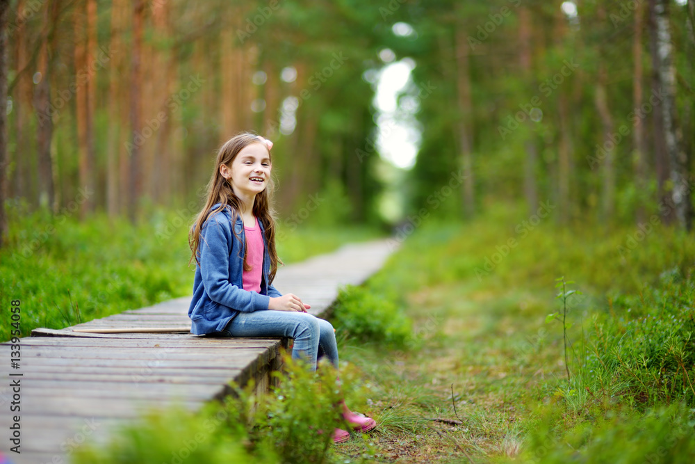 Cute little girl having fun during forest hike Cute little girl having fun during forest hike