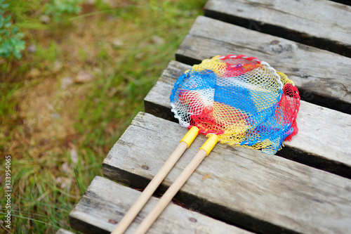 Two butterfly nets on a wooden path photo