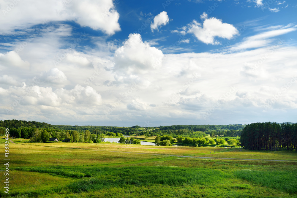 Scenic view of beautiful green Lithuanian countryside with a river in a distance