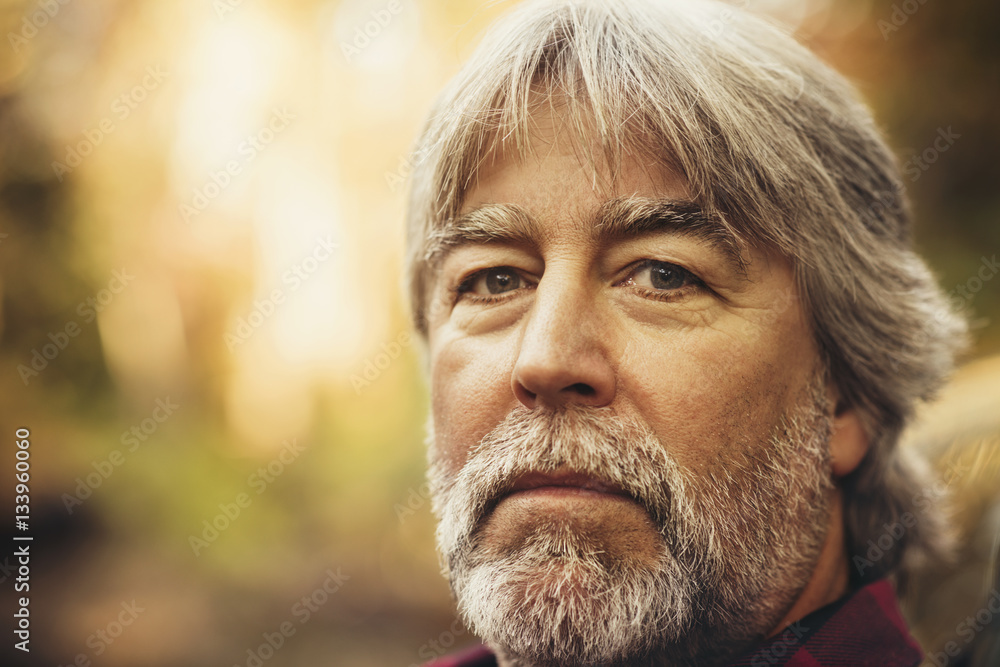 Close-up portrait of confident lumberjack in forest Close-up portrait of confident lumberjack in forest