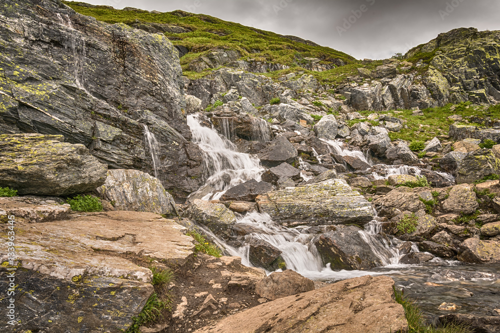 Fototapeta premium View on the waterfall from the road Trolltunga, Norway