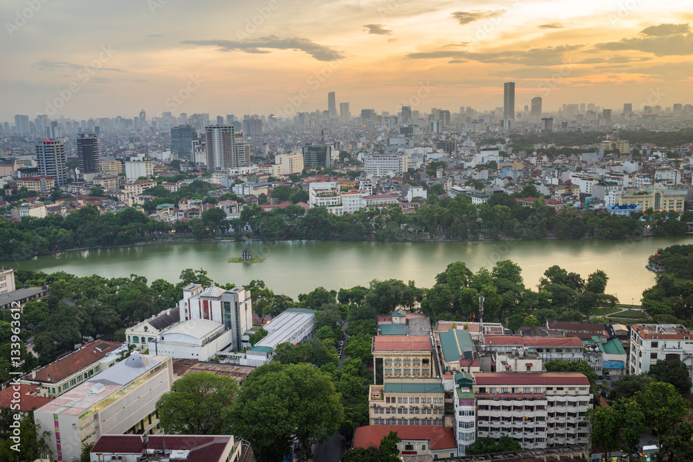 Obraz premium Aerial skyline view of Hoan Kiem lake (Ho Guom, Sword lake) area at twilight. Hoan Kiem is center of Hanoi city. Hanoi cityscape.