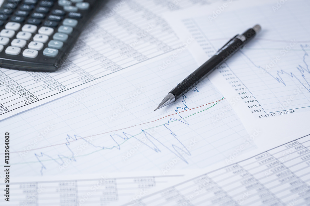 Shares with statistics and a pen Shares with statistics and a pen