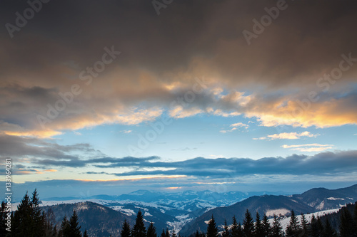Beautiful winter sunset with cloudy sky in the mountains. Carpathian mountains, Ukraine.